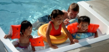 Anik, Yanmei, Thomas and Daji relaxing in the pool - Windsor, Canada, 2003
