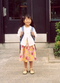 Yanmei outside the school door on her first school day, August 2005