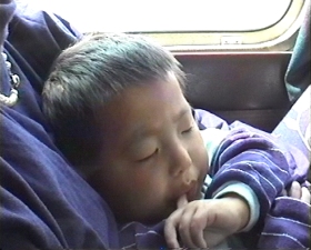Yanmei sleeping in the bus on the way to Lanzhou airport
