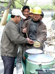 Worker renovating the Pagoda queuing for lunch