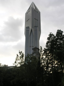 Old church tower infront of yet another Skyscraper