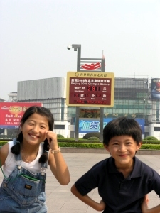 Yanmei and Daji infront of the countdown clock for the Olympics
