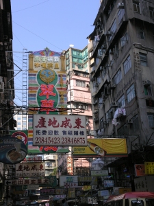 A typical Hong Kong street with signs, people and traffic